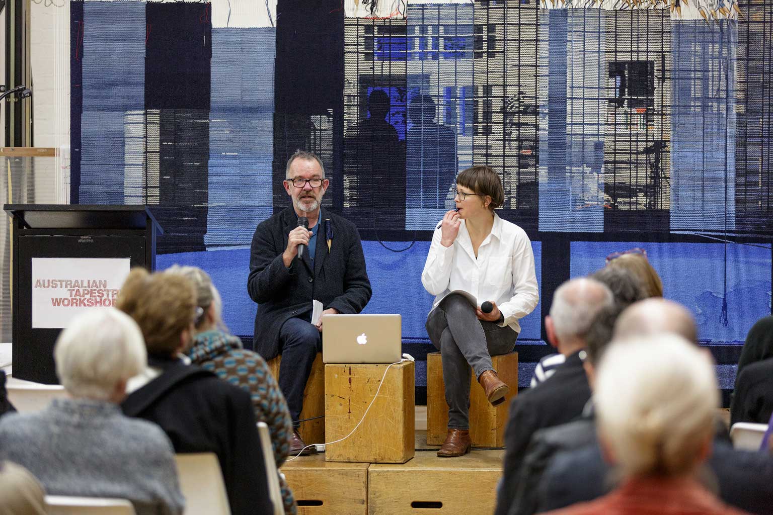 Architect Justin Hill & ATW weaver Karlie Hawking speaking at public lecture at the ATW, 2018. Photo: Jeremy Weihrauch.